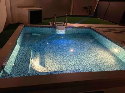 a large swimming pool with a blue tiled floor at Abbie's Private Pool Villa Bukit Mertajam Penang in Bukit Mertajam