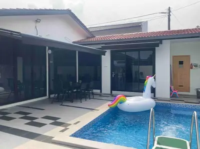 a swimming pool with a float in a house at Abbie's Private Pool Villa Bukit Mertajam Penang in Bukit Mertajam