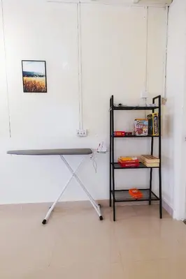 a desk in a room with a shelf at monstera homestay (Lenggong) in Kampong Ulu Jepai