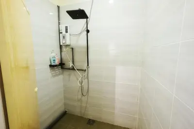 a shower stall in a bathroom with a shower at monstera homestay (Lenggong) in Kampong Ulu Jepai