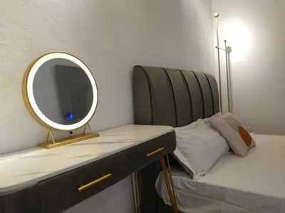 a mirror sitting on a table next to a bed at Bole Villa-Private Pool-BBQ-Karaoke 20pax in Ipoh