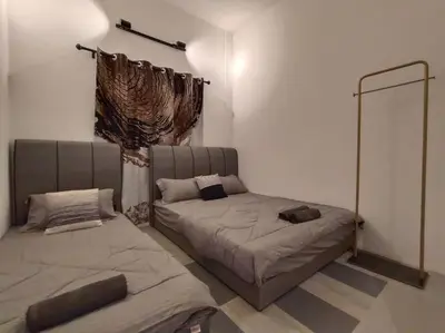 a bedroom with two beds in a room at Bole Villa-Private Pool-BBQ-Karaoke 20pax in Ipoh