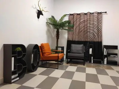 a room with chairs and a sign on a checkered floor at Bole Villa-Private Pool-BBQ-Karaoke 20pax in Ipoh