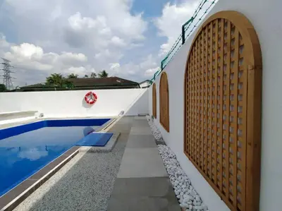 a house with a swimming pool and a wooden fence at Bole Villa-Private Pool-BBQ-Karaoke 20pax in Ipoh