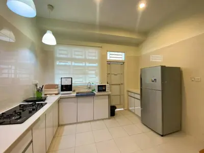 a large kitchen with a refrigerator and a stove at Modern COZY SINGLE STOREY HOUSE ```` ALMA JUSCO BM in Bukit Mertajam