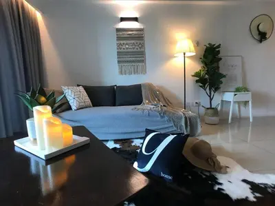 a living room with a couch and a table at 34zer0 Kinta Riverfront Suites 6pax in Ipoh