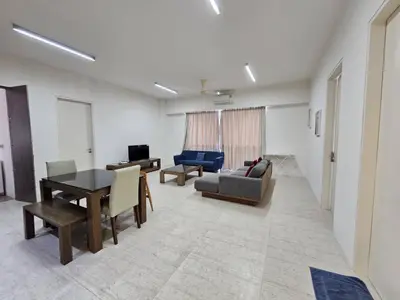 a living room with a couch and a table at By The Sea Partial Seaview n Mountain View 383 in Batu Ferringhi
