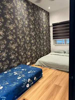 a bedroom with two beds and a wall with flowers at Adik Aisyah Black forest Cameron Highlands homestay For Muslim in Cameron Highlands