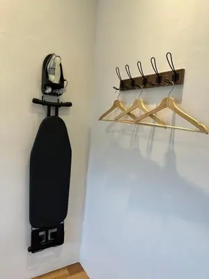a black skateboard hanging on a wall with hangers at Adik Aisyah Black forest Cameron Highlands homestay For Muslim in Cameron Highlands
