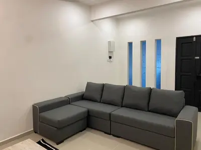 a living room with a couch in a room at Dudu Guesthouse Ipoh in Ipoh