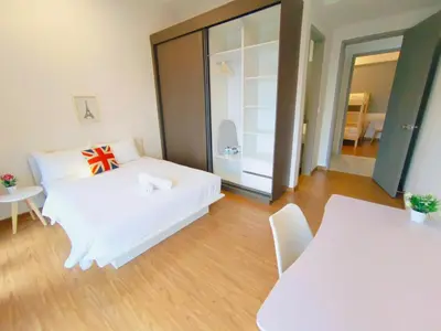 a room with a white bed and a table and chairs at Rooftop Pool, 8 Pax, 2 Bedrooms, 2 Bathrooms, 2 Car Parks by Star Home in Jelutong