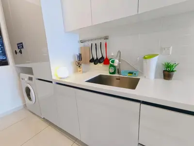 a white kitchen with a sink and a dishwasher at Rooftop Pool, 8 Pax, 2 Bedrooms, 2 Bathrooms, 2 Car Parks by Star Home in Jelutong