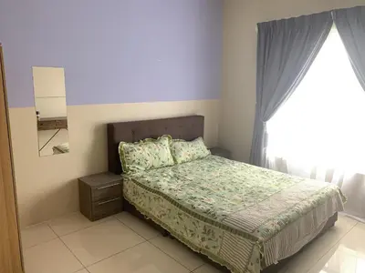 a bedroom with a bed and a window at Ipoh Waterpark Pool View Homestay in Ipoh