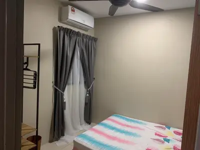 a bedroom with a bed and a window with a curtain at Ipoh Waterpark Pool View Homestay in Ipoh