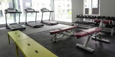 a gym with a row of exercise bikes at Ipoh Waterpark Pool View Homestay in Ipoh