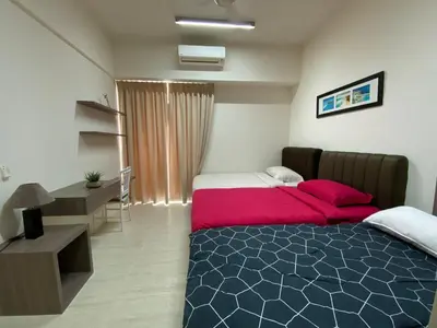 a bedroom with a bed with red pillows and a desk at By The Sea Side Seaview and Mountain View 252 in Batu Ferringhi