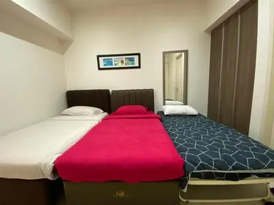 a bedroom with a large bed with a red blanket at By The Sea Side Seaview and Mountain View 252 in Batu Ferringhi