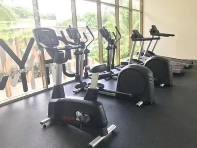 a row of exercise bikes in a gym at By The Sea@Side Seaview n Side Pool view (C3A3A) in Batu Ferringhi