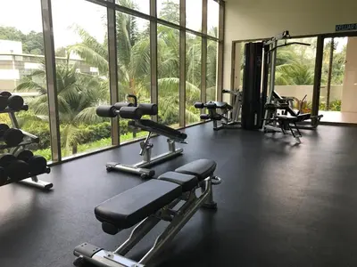 a gym with several tread machines and large windows at By The Sea@Side Seaview n Side Pool view (C3A3A) in Batu Ferringhi
