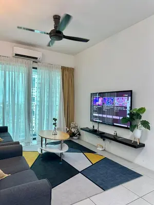 a living room with a tv and a couch and a table at Spacious 3BR I Meritus Perai l Family & Nice View in Perai