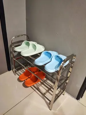 a rack with hats and flip flops on it at 7&9 Manhattan Condominium Ipoh in Ipoh