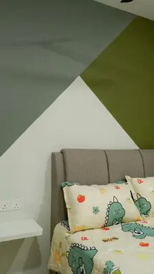 a bedroom with a bed with a headboard and pillows at 7&9 Manhattan Condominium Ipoh in Ipoh