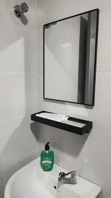 a bathroom with a sink and a mirror on a wall at 7&9 Manhattan Condominium Ipoh in Ipoh