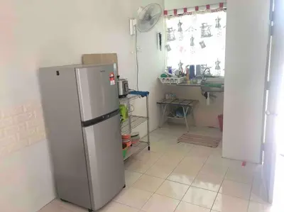 a kitchen with a refrigerator and a sink at 3 Rooms Apartment - Near Beach in Kampong Sungai Udang