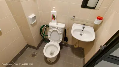 a bathroom with a toilet and a sink at 3 Rooms Apartment - Near Beach in Kampong Sungai Udang