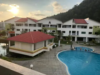 a view of a hotel with a swimming pool at 3 Rooms Apartment - Near Beach in Kampong Sungai Udang