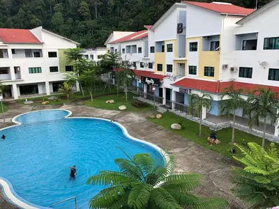 an overhead view of a swimming pool in front of buildings at 3 Rooms Apartment - Near Beach in Kampong Sungai Udang