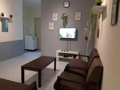a living room with a couch and a tv at Ammar Homestay Gua Musang in Gua Musang