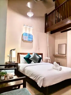 a bedroom with two beds and a staircase at Le Meilleur in George Town