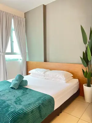 a bedroom with a bed with a blue towel on it at Spice Arena Guesthouse in Bayan Lepas