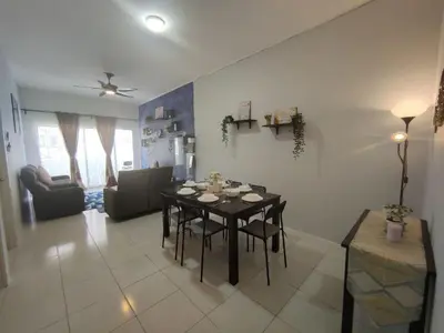 a living room with a dining table and a living room with a couch at FZHomestays in Cameron Highlands in Cameron Highlands