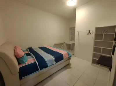 a small bedroom with a bed and a bathroom at FZHomestays in Cameron Highlands in Cameron Highlands