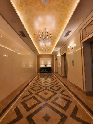 an empty hallway with a chandelier and a large room at A Modern & Homely Studio with Pool and Gym in Kampar