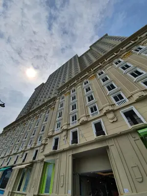 a large building with a tall building at A Modern & Homely Studio with Pool and Gym in Kampar
