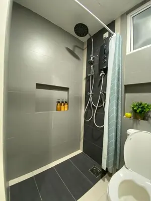 a bathroom with a shower and a toilet at A Modern & Homely Studio with Pool and Gym in Kampar
