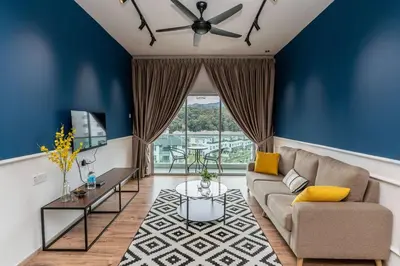 a living room with blue walls and a couch at Sunrise Terrace at Quintet (3BR/8 pax) in Tanah Rata
