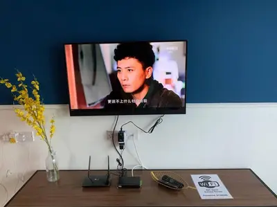a flat screen tv on a wall with a table at Sunrise Terrace at Quintet (3BR/8 pax) in Tanah Rata
