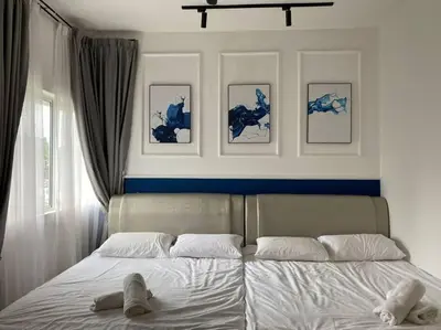 a bedroom with a bed with two shoes on it at Sunrise Terrace at Quintet (3BR/8 pax) in Tanah Rata