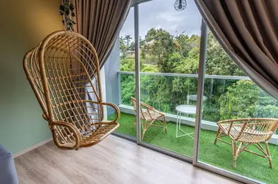 a room with a large window with chairs and a table at Green Terrace at Quintet (3BR/ 8 Pax） in Tanah Rata