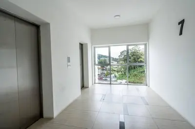 an empty hallway with a large window in a building at Green Terrace at Quintet (3BR/ 8 Pax） in Tanah Rata
