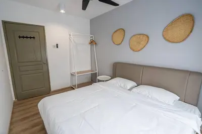 a bedroom with a white bed and a green door at Green Terrace at Quintet (3BR/ 8 Pax） in Tanah Rata