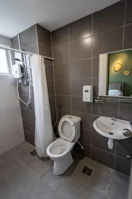 a bathroom with a toilet and a sink at Green Terrace at Quintet (3BR/ 8 Pax） in Tanah Rata