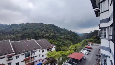 an aerial view of a city with a mountain at A One Holiday Apartment - PRO in Tanah Rata