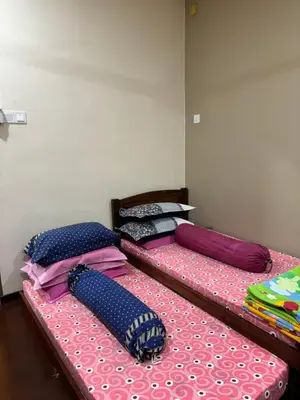 two twin beds sitting in a room at Homestay Hajrah in Ipoh