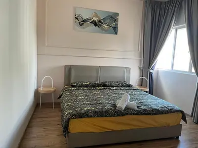 a bedroom with a bed with two towels on it at City Retreat at Quintet(3BR/8pax) 9 Jalan PMCJ, Tanah Rata in Tanah Rata
