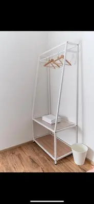 a white book shelf in the corner of a room at City Retreat at Quintet(3BR/8pax) 9 Jalan PMCJ, Tanah Rata in Tanah Rata
